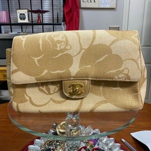 Chanel Camellia Print Medium Flap Bag in raffia with gold hardware.